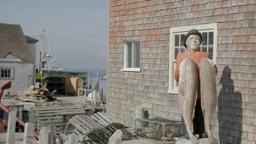 A statue of a man holding two fish