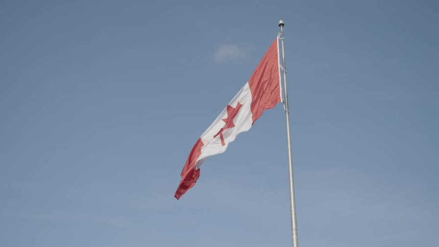 The canadian flag flutters in the breeze