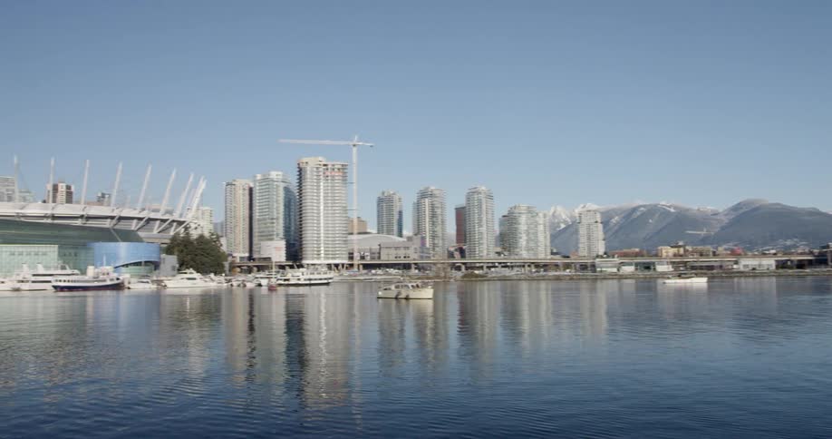 The buildings downtown reflect on the water
