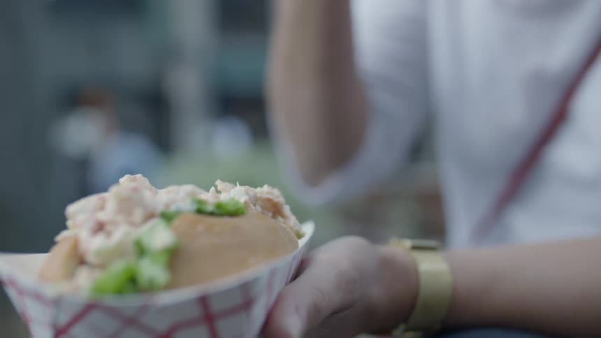 A man eats the filling out of a sandwich with a fork