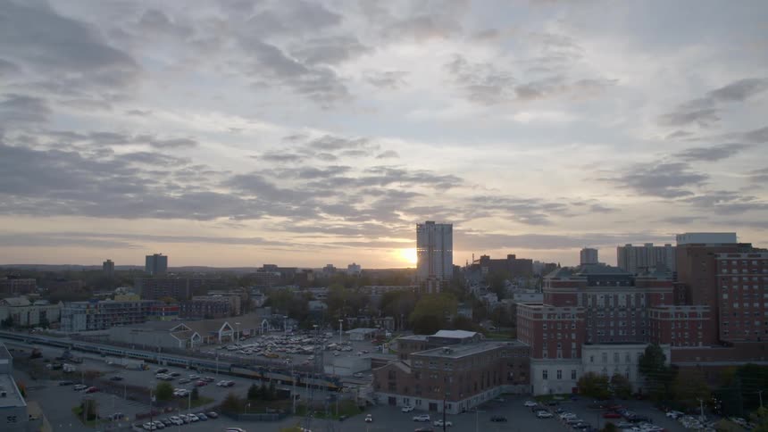 Aerial shot of a city skyline at dawn at first out of focus and then in focus