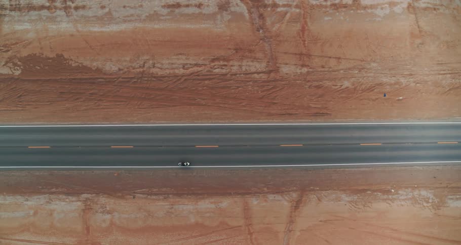 A motorcycle pulls back onto an empty road
