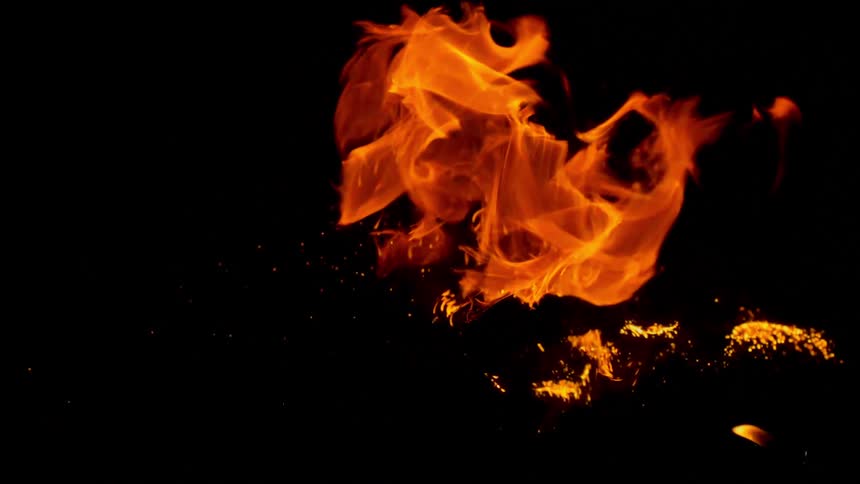 Close up of flames burning in slow motion against a dark background
