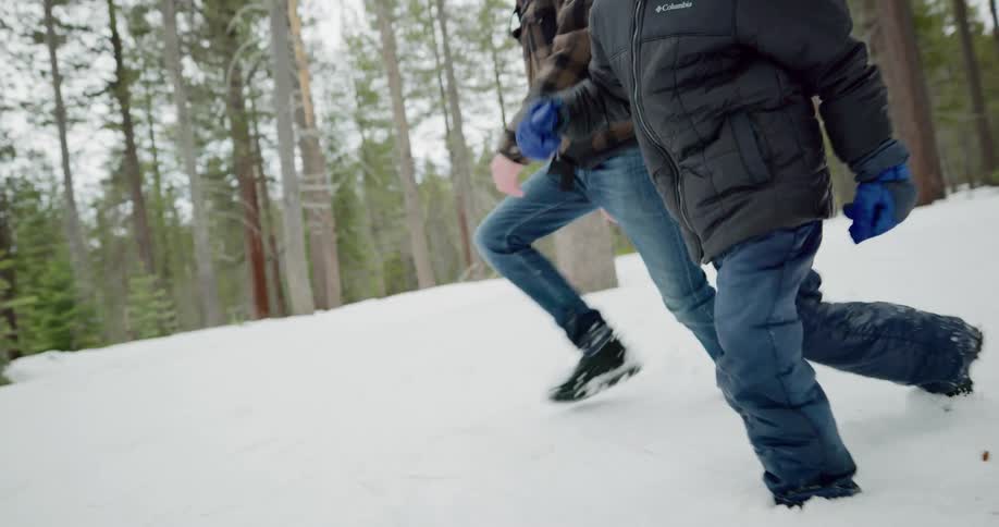 Two people trek through the snow together
