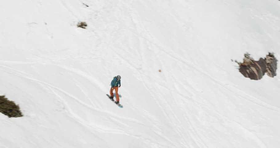 A man snowboards down a hill