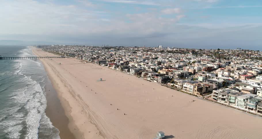 Aerial view of the coastal city and empty beach
