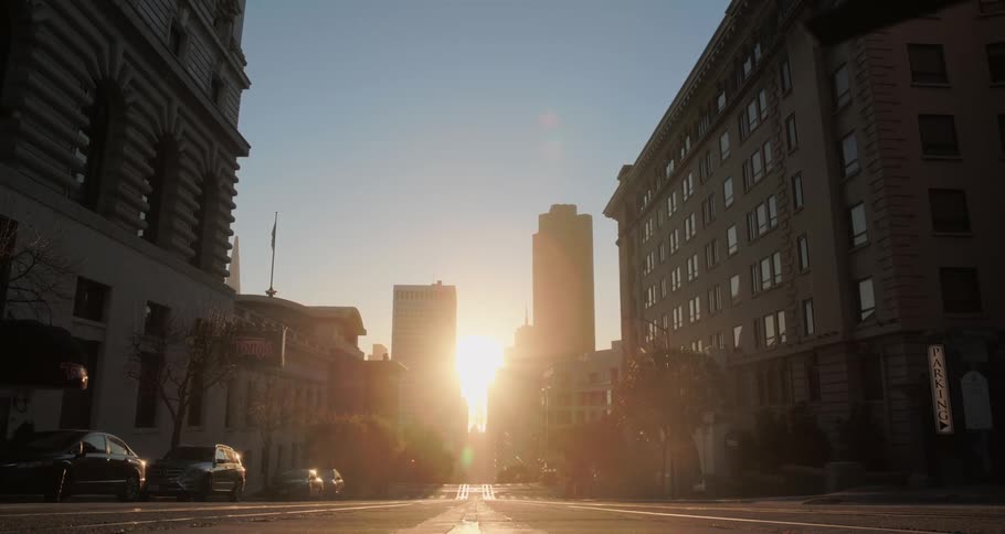 The sun is rising over the empty city