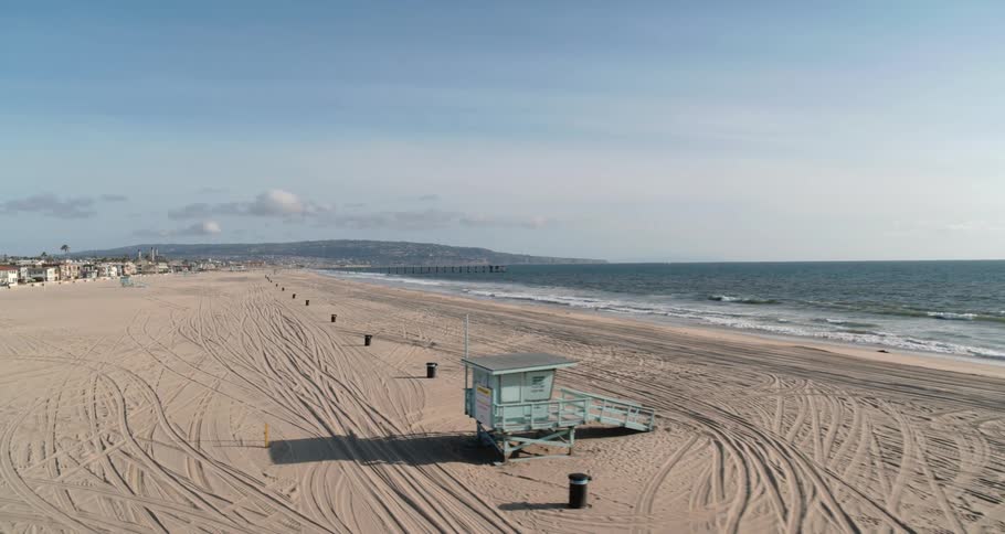 Aerial view of white sand at beach near neighborhood at day