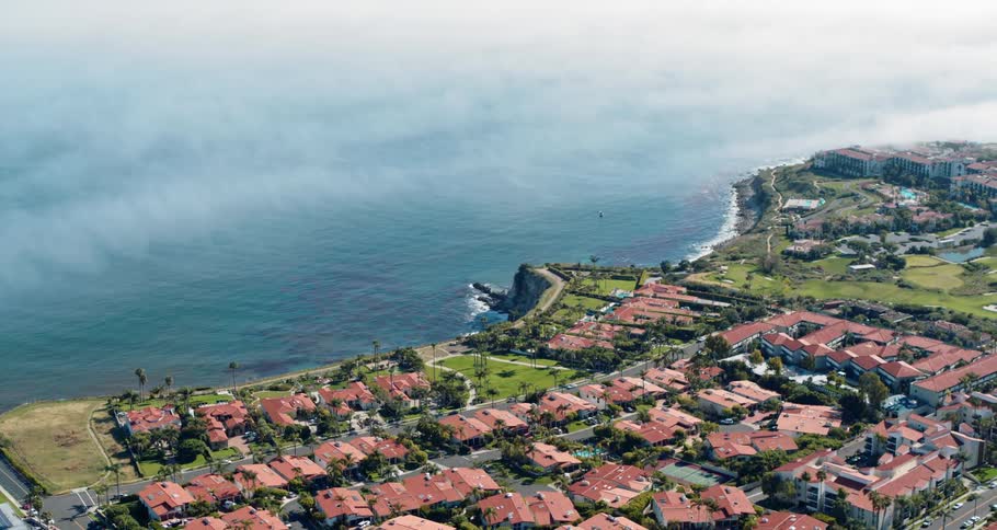 Neighborhood buildings sit near the ocean