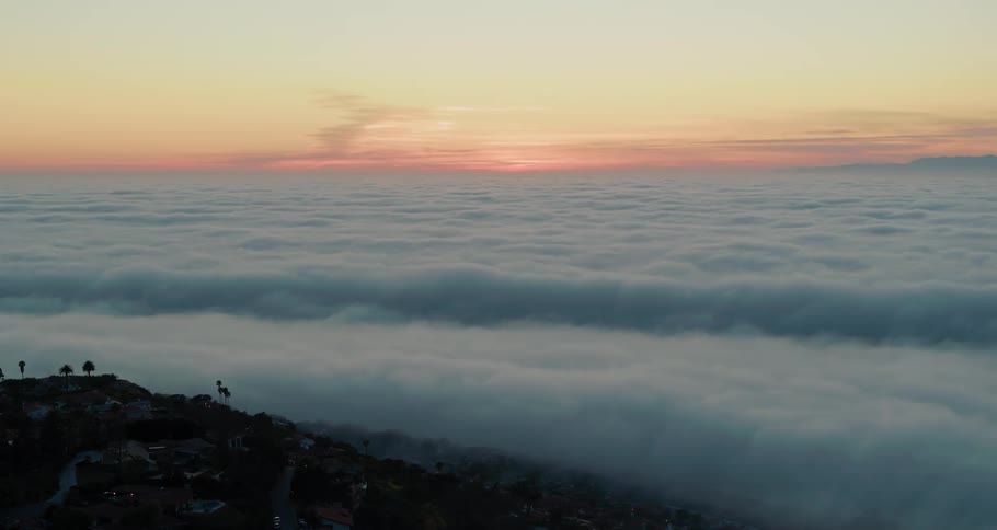 A town near the coast with a foggy sea and the sky in the background