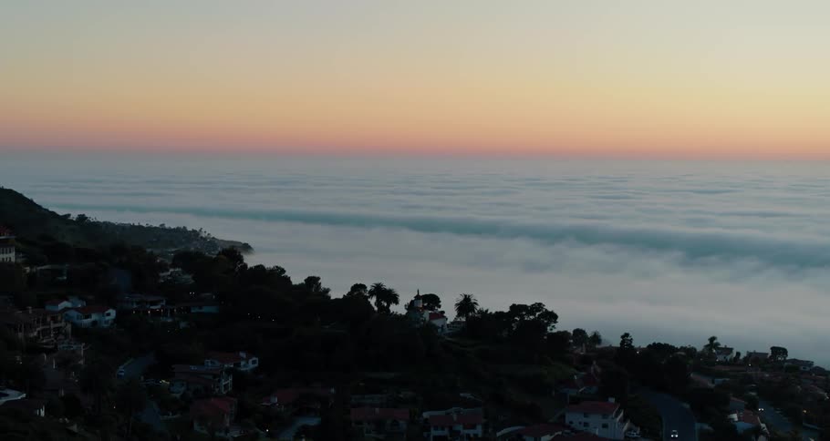 The sun is setting over the coastal town