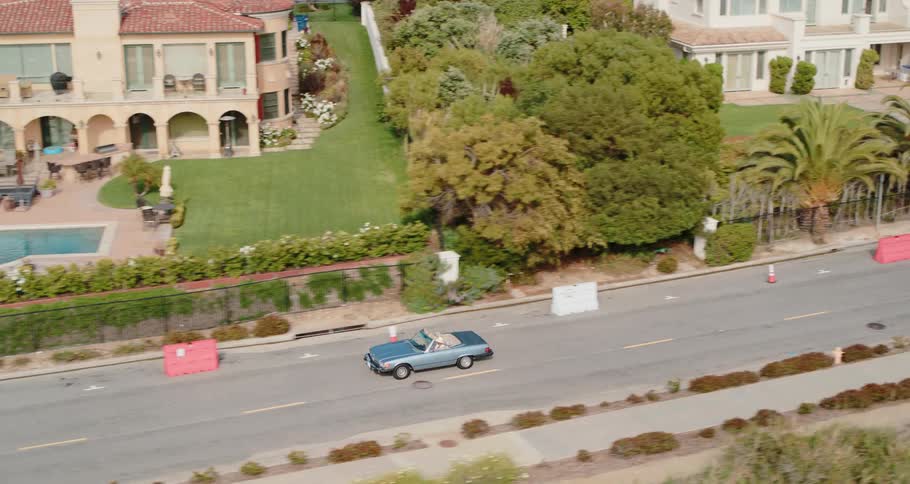 The car drives down the road
