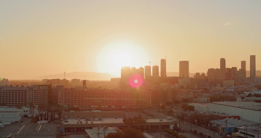 Buildings in a city sit as the sun rises