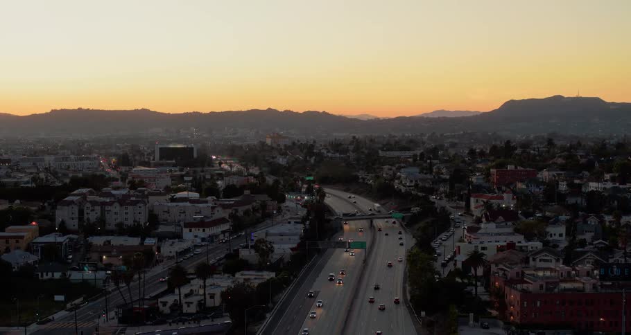Cars driving down a highway in the city