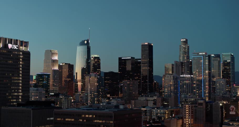A shot of a city skyline at night from the air with the camera slowly zooming out
