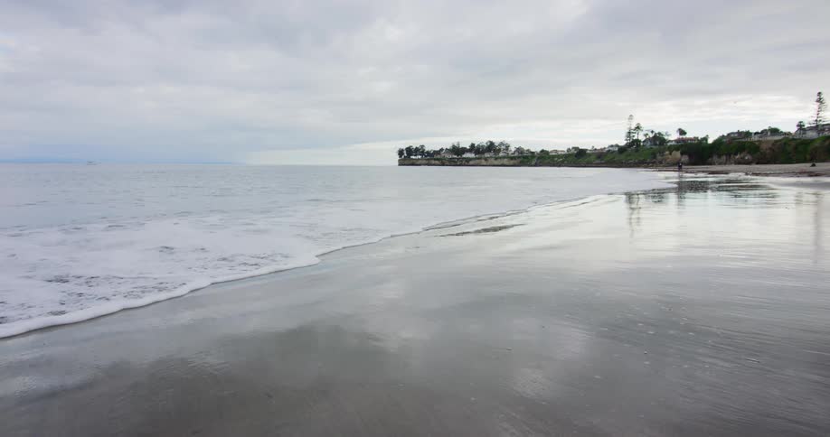 The tide comes in on a remote beach