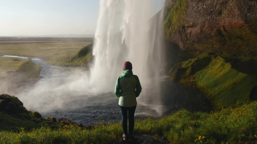 A person watches a waterfall