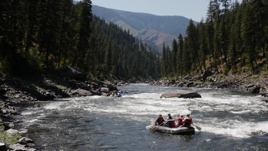 People Rafting On River