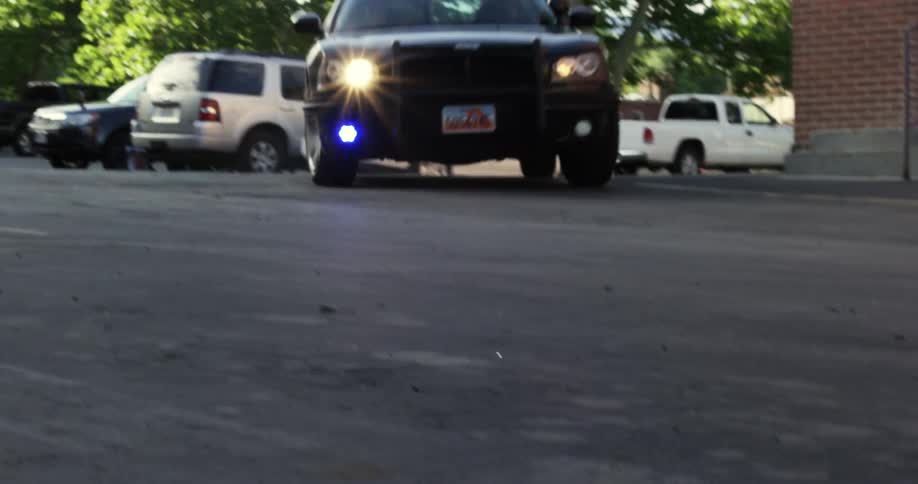 A police car makes a quick turn before speeding off