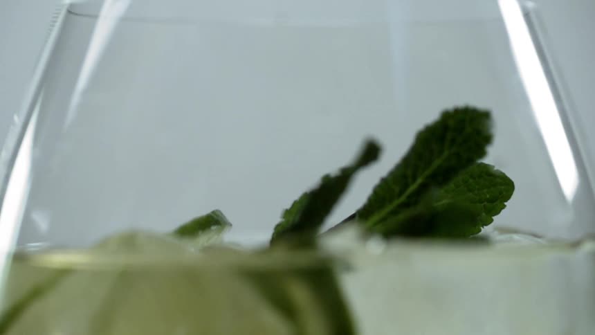 A leaf drops into a wine glass