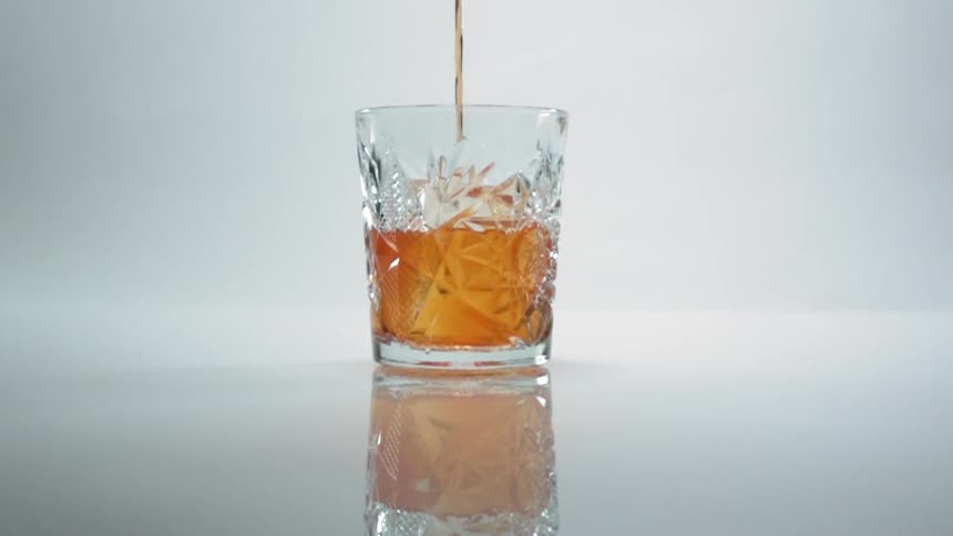 A drink is pouring into the glass