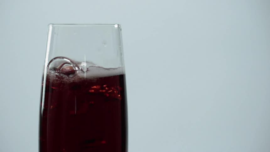 The fruit drops into the glass