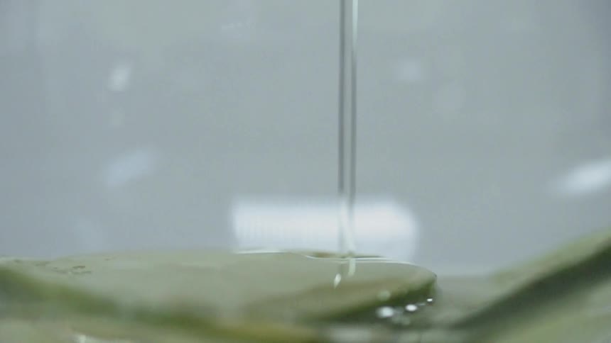 Liquid is slowly pouring down in a line