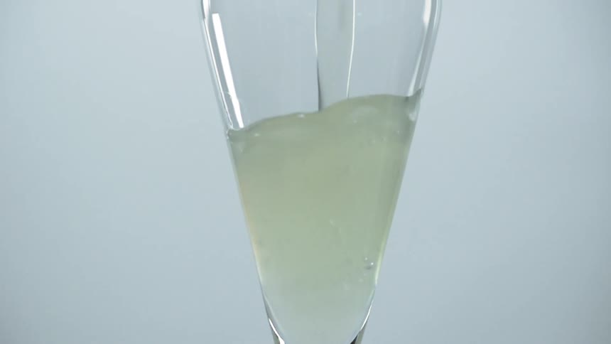 Lemonade is being poured into the glass