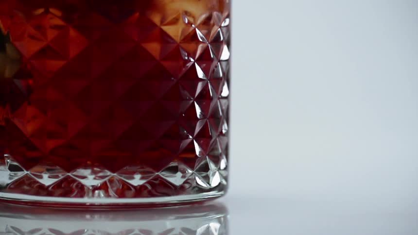 A glass filled with liquids is displayed