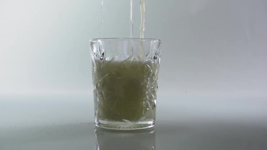 Three streams of liquid are poured into a beveled glass