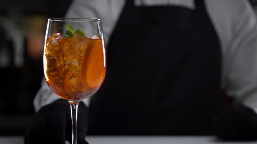 A person sets a drink down on a table