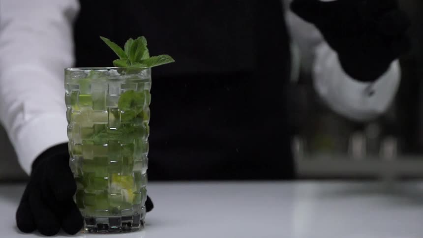 A bartender is making an alcoholic drink