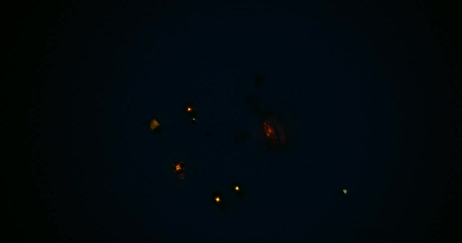 Aerial rising above tents in a snowy camp at night