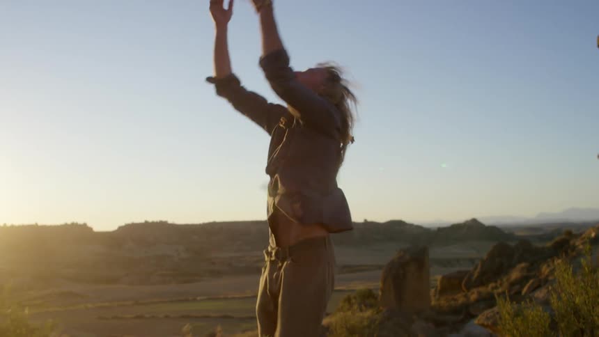 The man is dancing in the desert