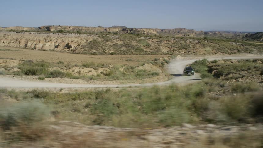 A car is driving through a rural area