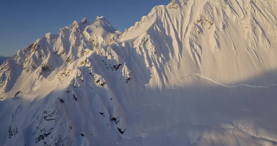 Impressive snow covered mountain aerial