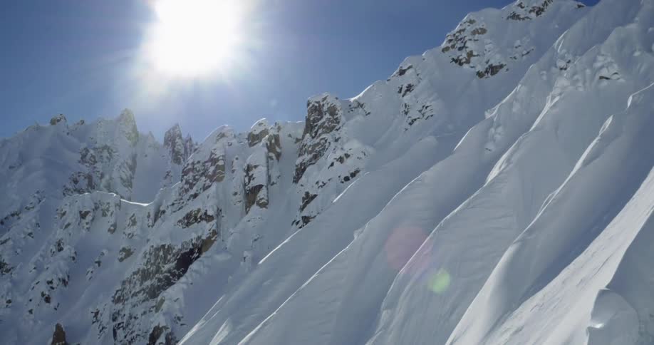 Aerial push towards huge mountain ridges