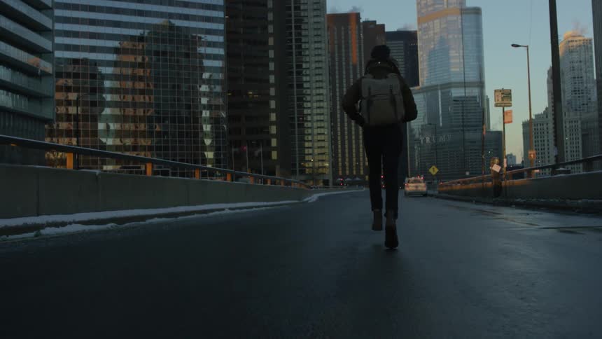 A man runs down a city street