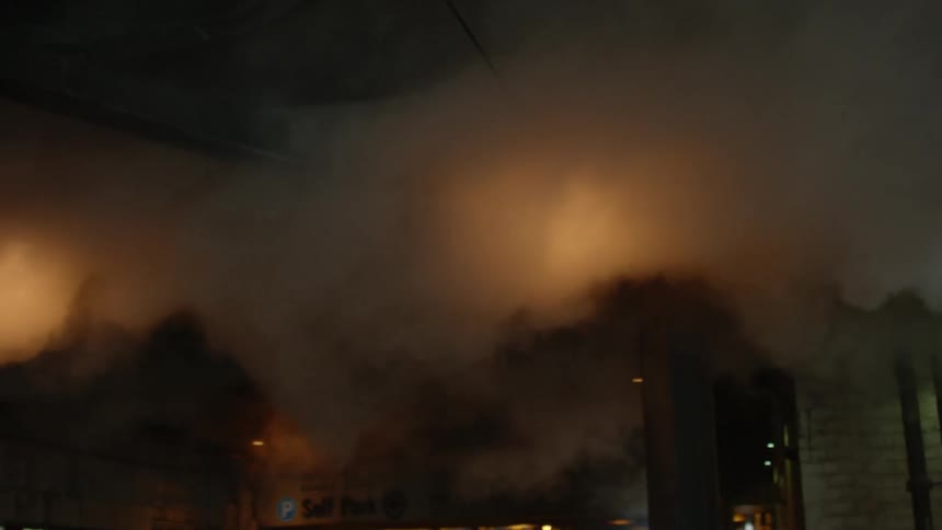 Smoke can be seen moving across a dark area
