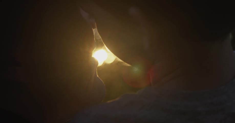 Closeup of a woman holding a young boy as their heads meet