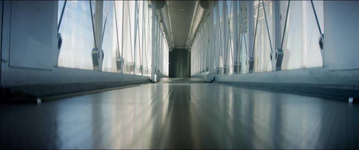 An empty hallway lined with windows on a sunny day