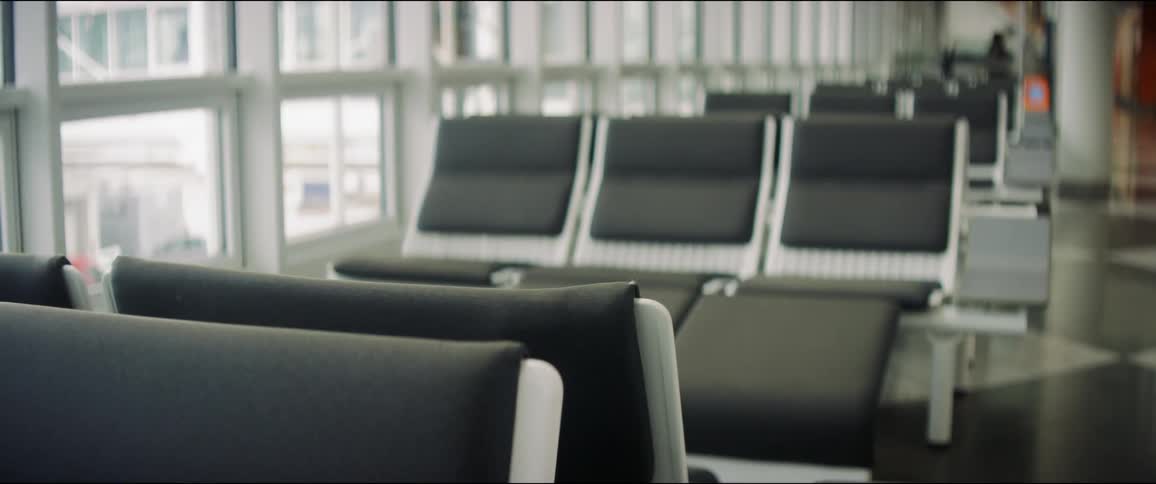 Empty seats near large windows in a terminal