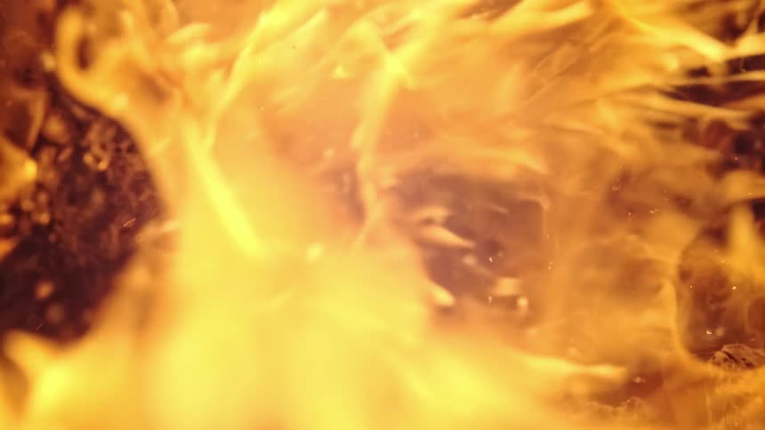 Fire flows across wood as it ignites