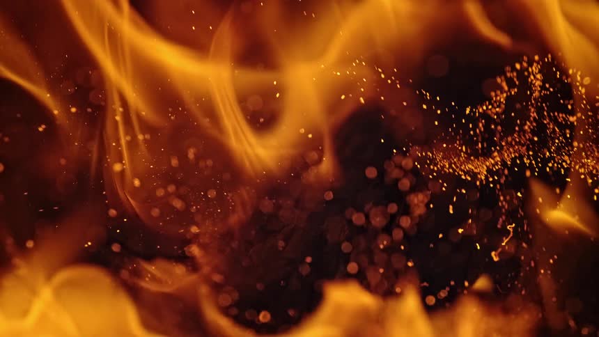 Flame billows against a dark background