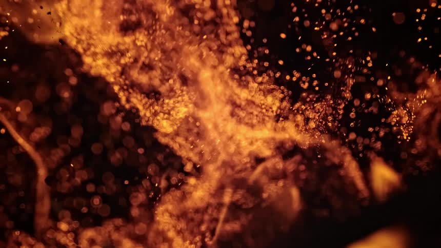 Burning flames grow taller and sent pieces of ember up and out