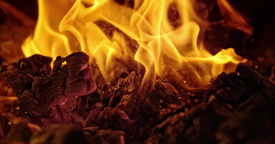 A bonfire is displayed at night