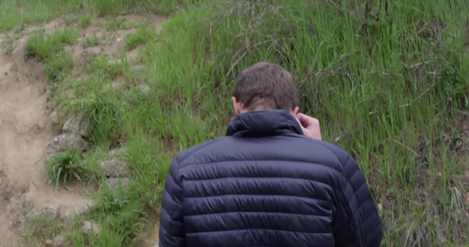 A young man walks outside