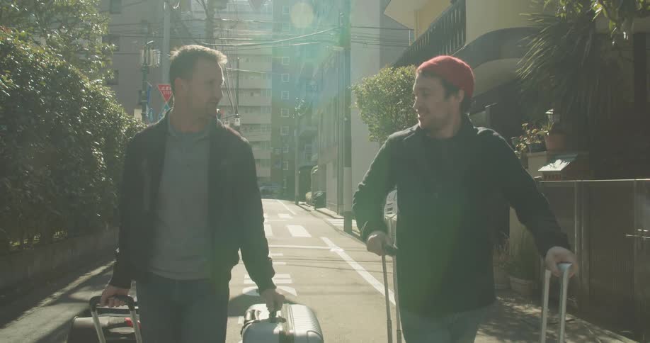 Two men walk with luggage