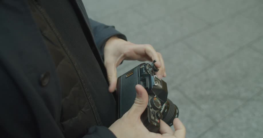 A man replaces the film in a camera