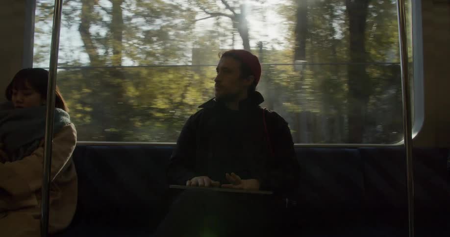Two people sit on a bus